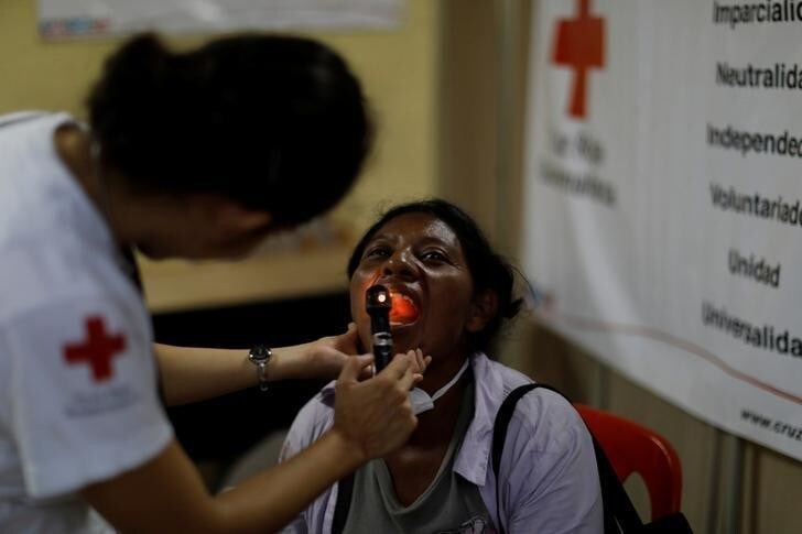 Eufemia Garcia, 48, who lost 50 members of her family during the eruption of the Fuego volcano, is examined by a doctor after a long day searching for her family in Escuintla, Guatemala, June 14, 2018. REUTERS/Carlos Jasso SEARCH "EUFEMIA MISSING" FOR THIS STORY. SEARCH "WIDER IMAGE" FOR ALL STORIES.