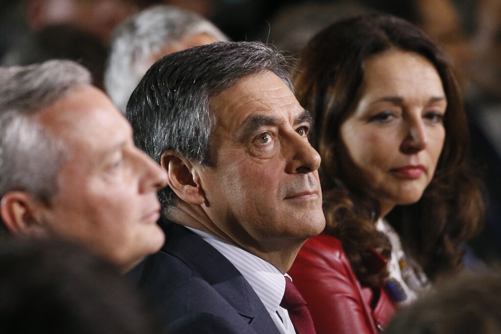 Former candidate Bruno Le Maire (L) sits with candidate Francois Fillon (C), former French prime minister and member of Les Republicains political party, as they attend a campaign rally in the second round for the French center-right presidential primary election in Lyon, France, November 22, 2016. REUTERS/Robert Pratta - RTSSUF1