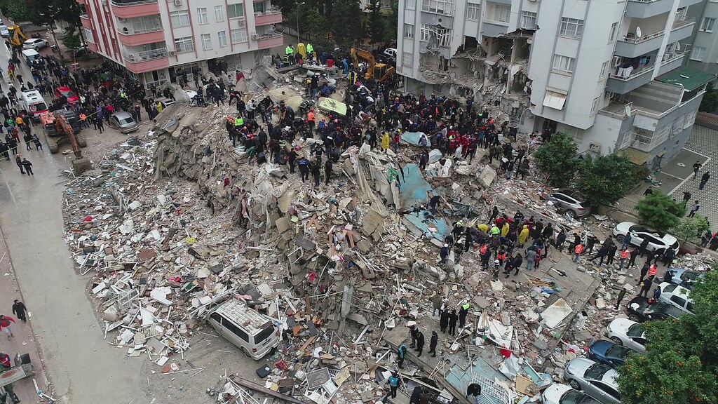 People search through rubble following an earthquake in Adana, Turkey.
