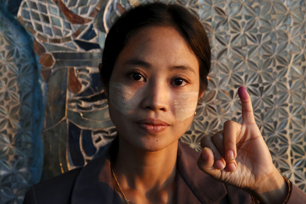 A woman shows her inked finger after voting at a Buddhist prayer hall during the general election in Mandalay, Myanmar, November 8, 2015. Voting began on Sunday in Myanmar's first free nationwide election in 25 years, the Southeast Asian nation's biggest stride yet in a journey to democracy from dictatorship. REUTERS/Olivia Harris - RTS5Z2Y
