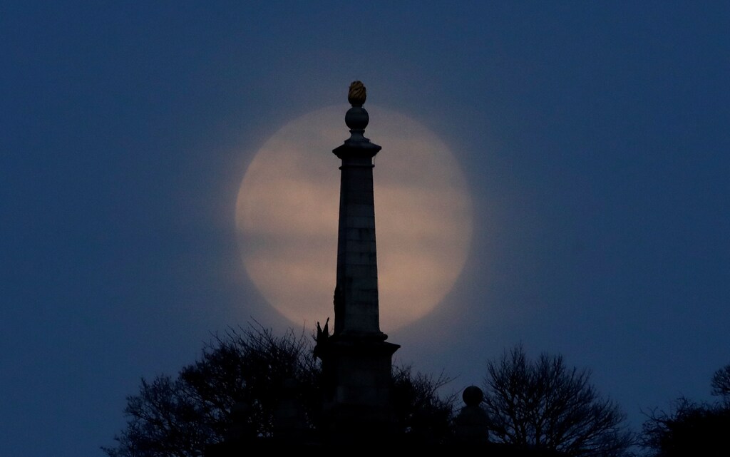 The Pink Supermoon rises over Coombe Hill in the Chilterns in an astronomical event that occurs when the moon is closest to the Earth in its orbit, making it appear much larger and brighter than usual, near Dunsmore, Britain, April 7, 2020. REUTERS/Matthew Childs - RC2VZF9PZZ71