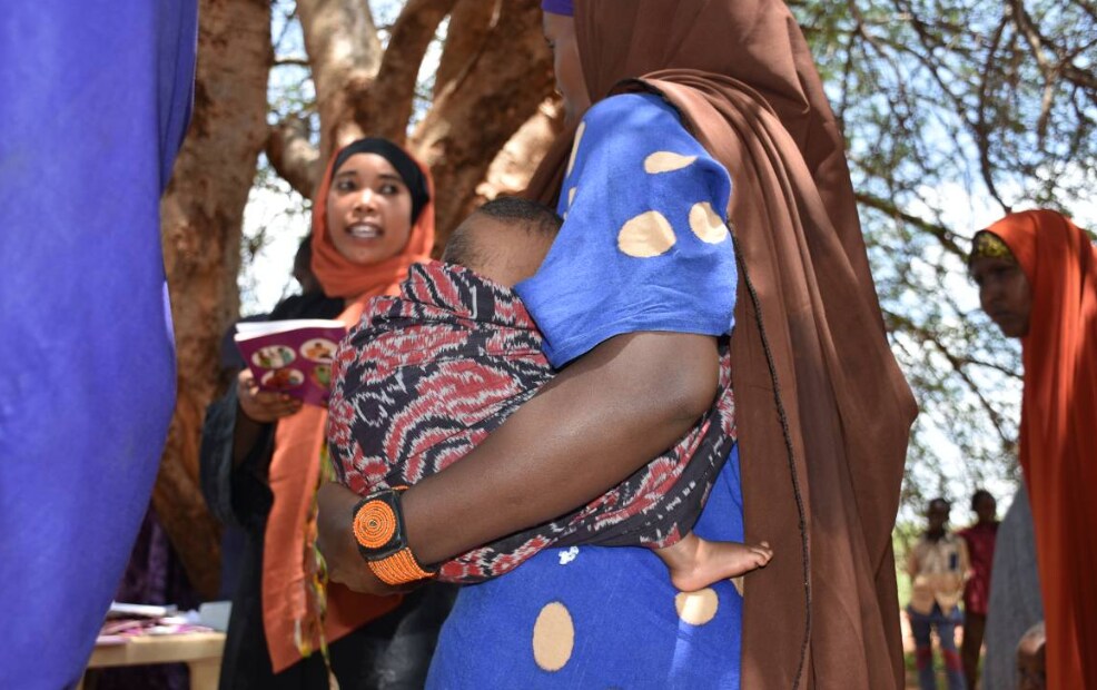 Alima Hossain, wearing a beaded solar-powered GPS bracelet, waits for her turn for health check-up in Yaballo Godha, Moyale, Kenya, April 8, 2019. Thomson Reuters Foundation/Munyaradzi Makoni