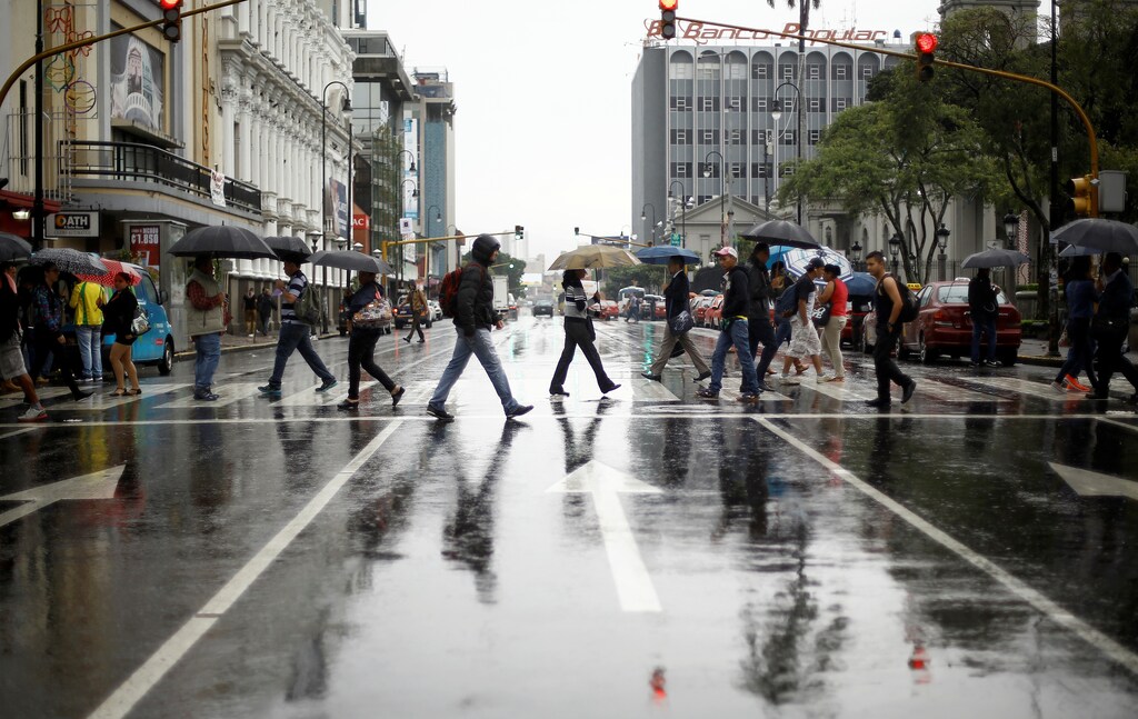 People walk on the main street of the city of San Jose, which looks empty as Hurricane Otto approaches in San Jose, Costa Rica November 24, 2016. REUTERS/ Juan Carlos Ulate - RTST5YE