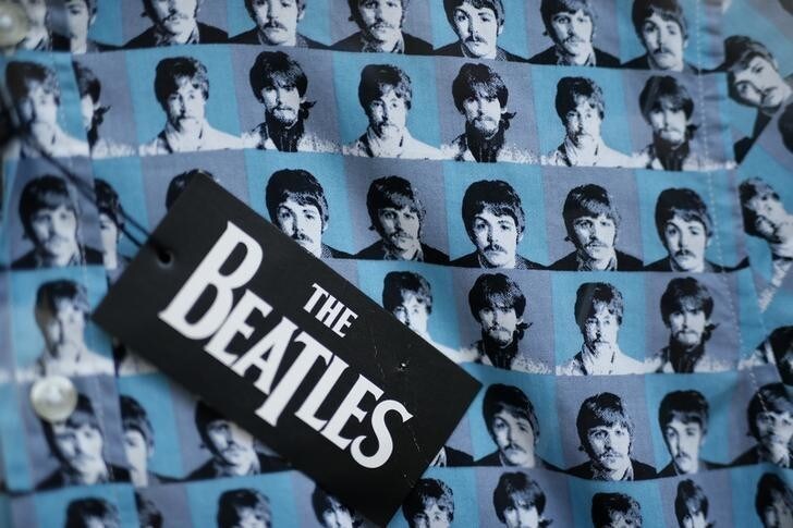 The faces of the four Beatles appear on the fabric of a shirt for sale in a shop in Liverpool northern England, March 2, 2015. Fifty years on since the group performed for the last time in their home city the group's presence is still felt with fans of the Fab Four from across the globe adding around 70 million pounds sterling (US$105 million) to the local economy each year according to industry organisation UK Music. Picture taken on March 2. REUTERS/Phil Noble