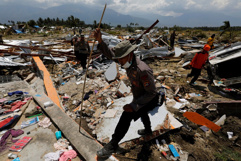 Policemen walk at the ruins of a church after an earthquake hit Jono Oge village in Sigi, Indonesia's Sulawesi island, October 3, 2018. REUTERS/Beawiharta