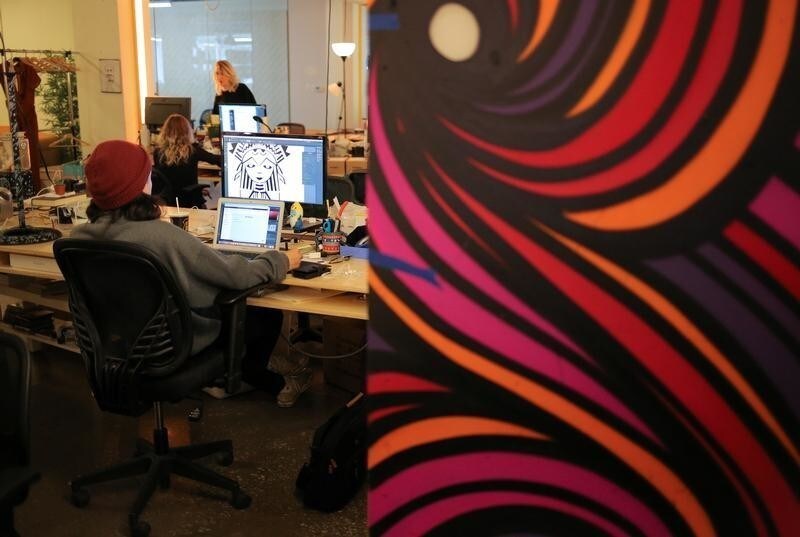 Staff at Inkbox, a temporary tattoo start-up, work on designs at their offices in Toronto, Ontario, Canada July 17, 2018. REUTERS/Chris Helgren - RC1F67B9B240