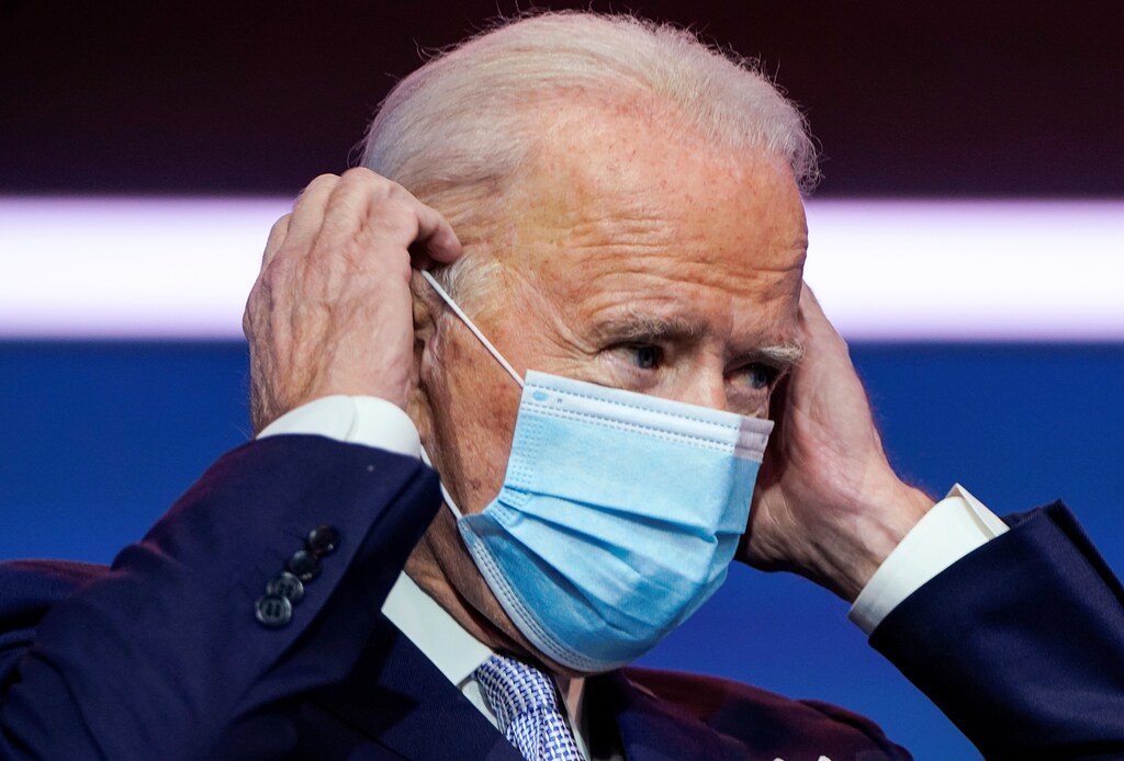 U.S. President-elect Joe Biden puts on his face mask as he announces his national security nominees and appointees at his transition headquarters in Wilmington, Delaware, U.S., November 24, 2020. REUTERS/Joshua Roberts - RC2U9K90JVPH