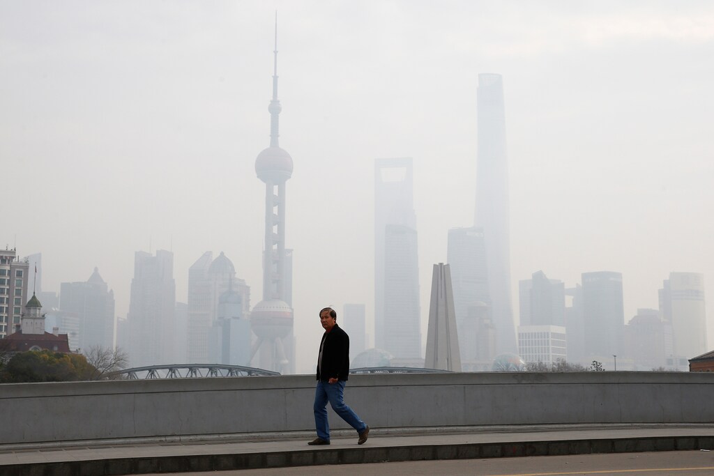 A man walks near the Bund during a polluted day in Shanghai, China, January 2, 2017. REUTERS/Aly Song - RTX2X6WH