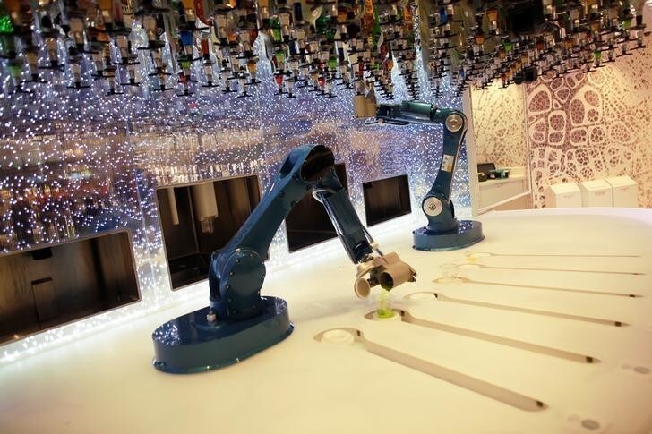 Robots serve drinks at the bionic bar, on the world's largest cruise ship of Royal Caribbean Cruises, the 362-metre-long, Symphony of the Seas, during its world presentation ceremony at a port in Malaga, Spain March 27, 2018. REUTERS/Jon Nazca