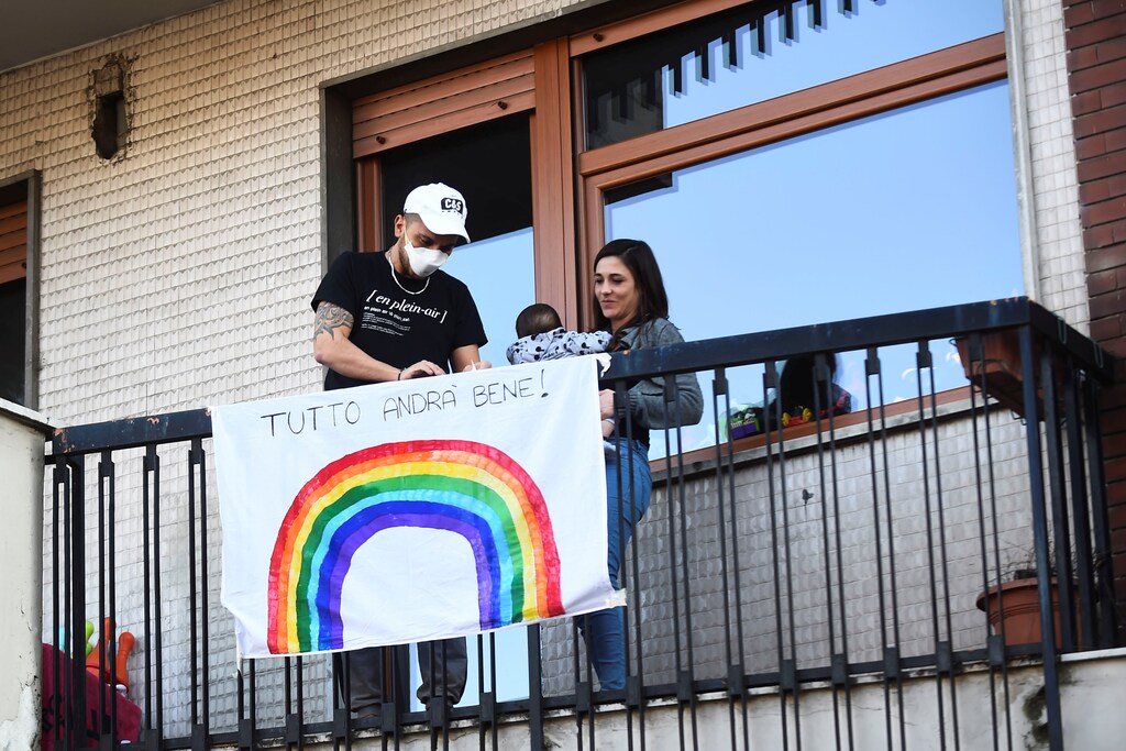 People place a banner on a balcony that reads "everything will be fine" after Italy orders a lockdown on the whole country aimed at beating the coronavirus, in Turin, Italy, March 11, 2020. REUTERS/Massimo Pinca - RC2SHF9PQVB0