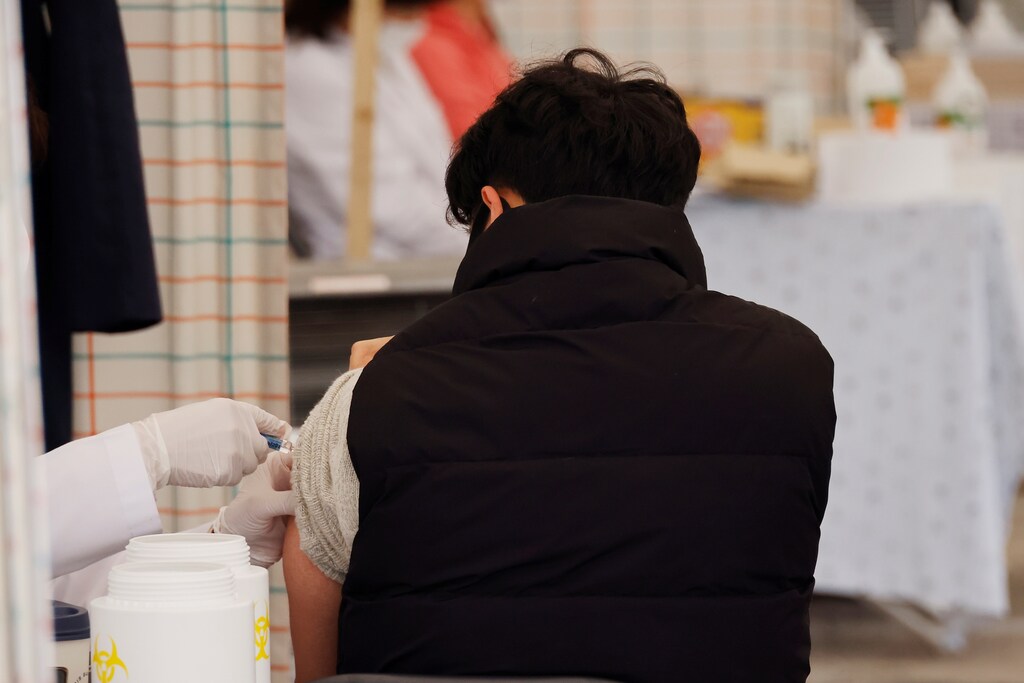 A man gets an influenza vaccine at a hospital in Seoul, South Korea