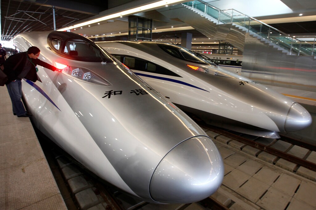 A man looks at the bullet trains serving the new high-speed railway linking Shanghai and Hangzhou in Shanghai October 26, 2010. REUTERS/Aly Song/File Photo - RTSKS22