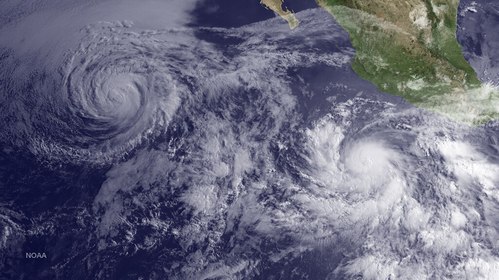 Hurricane Andres (L) is seen weakening as Tropical Storm Blanca strengthens off the coast of Baja California, Mexico, as seen in this image from NOAA's GOES West satellite taken at 11:00 am EDT (15:00 GMT) June 2, 2015. REUTERS/NOAA/Handout THIS IMAGE HAS BEEN SUPPLIED BY A THIRD PARTY. IT IS DISTRIBUTED, EXACTLY AS RECEIVED BY REUTERS, AS A SERVICE TO CLIENTS. FOR EDITORIAL USE ONLY. NOT FOR SALE FOR MARKETING OR ADVERTISING CAMPAIGNS - TM3EB620YOM01