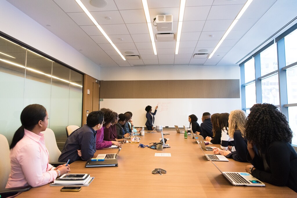 A woman leading a boardroom meeting, illustrating the pressures now facing CEOs