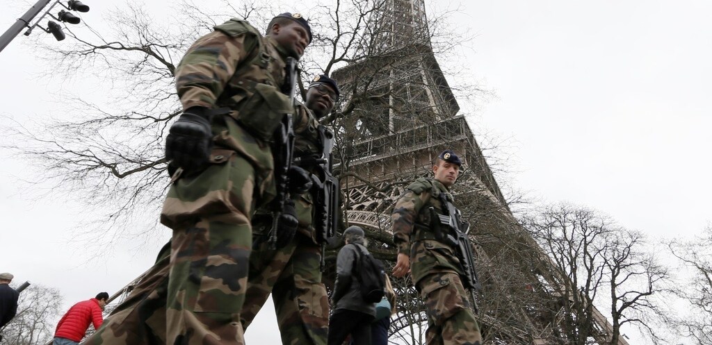 French soldiers patrol near the Eiffel Tower in Paris as part of the "Vigipirate" security plan December 23, 2014.