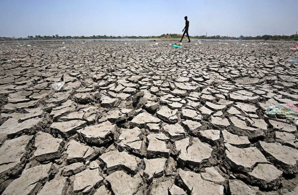 A man walks on a dried-up portion of Chandola Lake on the occasion of Earth Day, in Ahmedabad, India, April 22, 2018. REUTERS/Amit Dave - RC16ABB13CD0