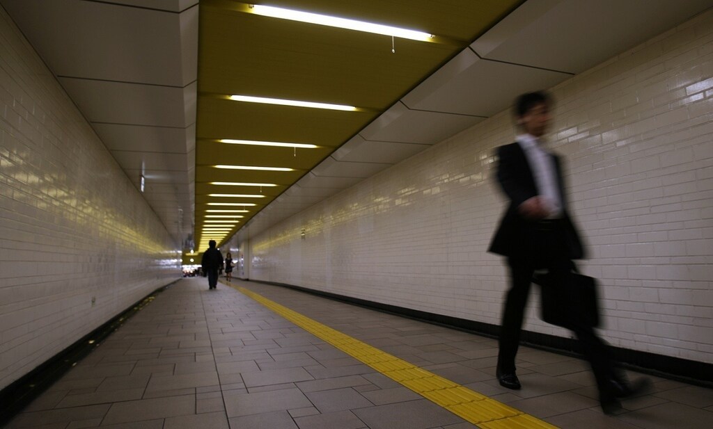 A businessman walks through a station in Tokyo June 27, 2008. REUTERS/Yuriko Nakao (JAPAN) - RTX7DXL
