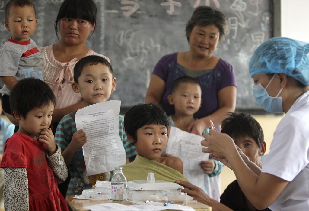 A student receives a measles vaccination at a primary school in Luoyang, Henan province September 11, 2010.