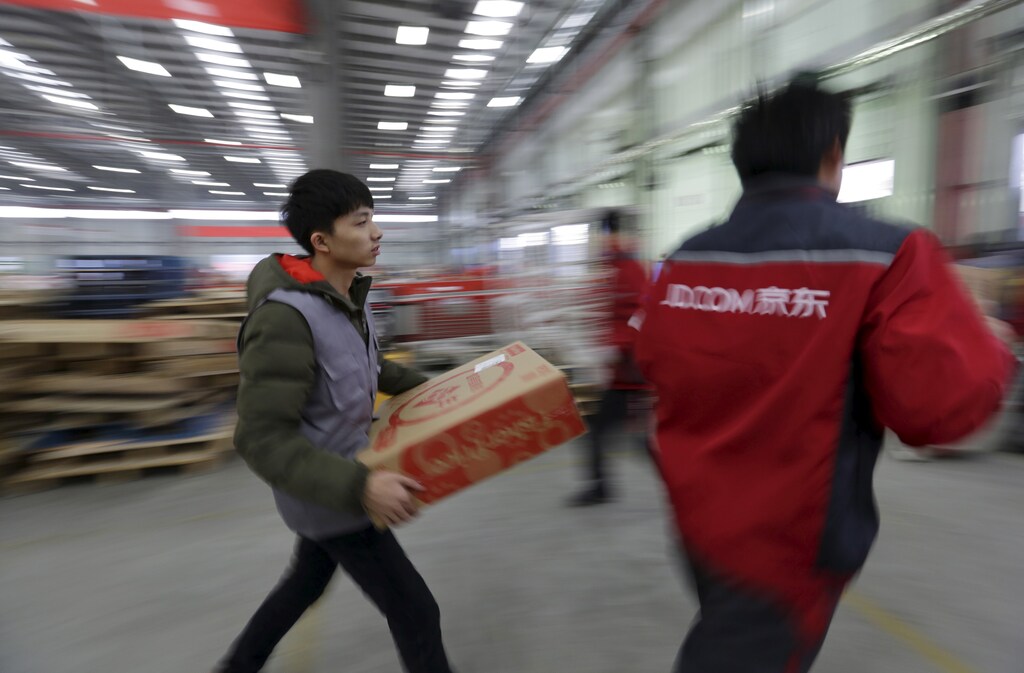 Employees work at a JD.com logistic centre in Langfang, Hebei province, November 10, 2015.