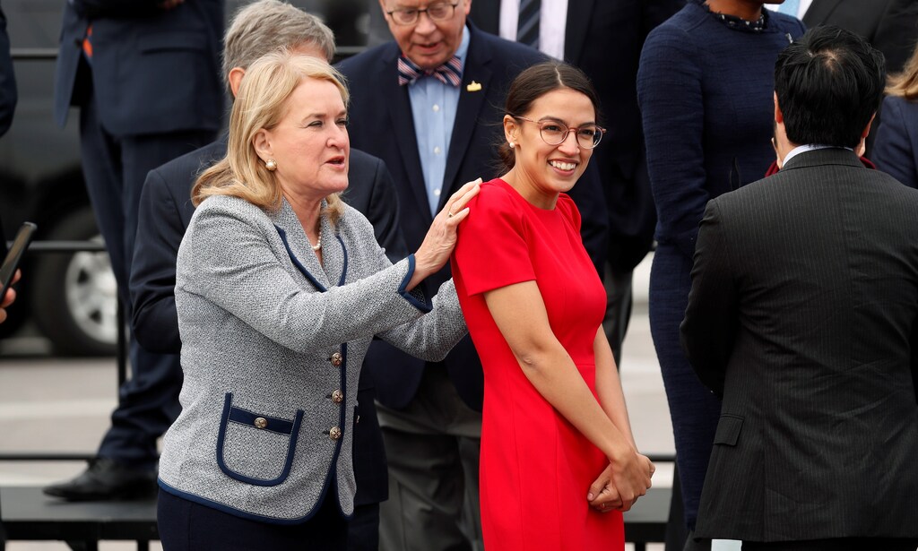 Democratic Representative-elect Susan Wild of Pennsylvania puts her hands on the shoulders of Representative-elect Alexandria Ocasio-Cortez of New York as they arrive for a class photo with incoming newly elected members of the U.S. House of Representatives on Capitol Hill in Washington, U.S., November 14, 2018. REUTERS/Kevin Lamarque - RC1139DC52B0