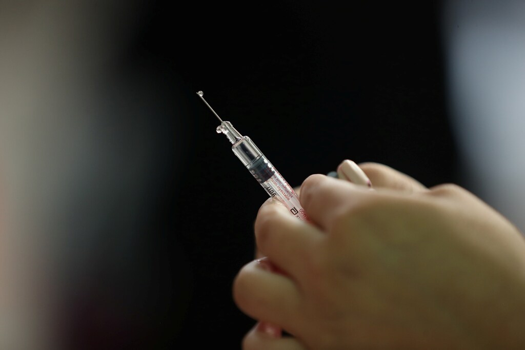 A nurse prepares a vaccine as part of the start of the seasonal flu vaccination campaign as a preventive measure due to the outbreak of coronavirus disease (COVID-19), in Santiago, Chile, March 16, 2020. Picture taken March 16, 2020.