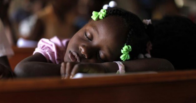 Image: A girl is asleep in a classroom in Haiti. REUTERS/Kena Betancur