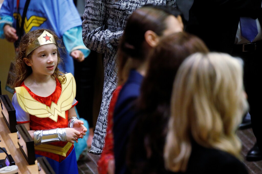 A child in a Wonder Woman outfit watches as photos are taken during an event to name Wonder Woman UN Honorary Ambassador for the Empowerment of Women and Girls at the United Nations Headquarters in the Manhattan borough of New York, New York, U.S., October 21, 2016. REUTERS/Carlo Allegri - RTX2PWPT