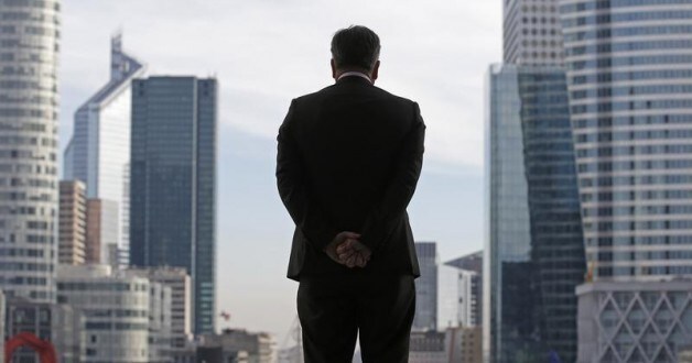 A Businessman is silhouetted as he stands under the Arche de la Defense, in the financial district west of Paris, November 20, 2012. France said its economy was sound and reforms were on track after credit ratings agency Moody's stripped it of the prized triple-A badge due to an uncertain fiscal and economic outlook. Monday's downgrade, which follows a cut by Standard & Poor's in January, was expected but is a blow to Socialist President Francois Hollande as he tries to fix France's finances and revive the euro zone's second largest economy.