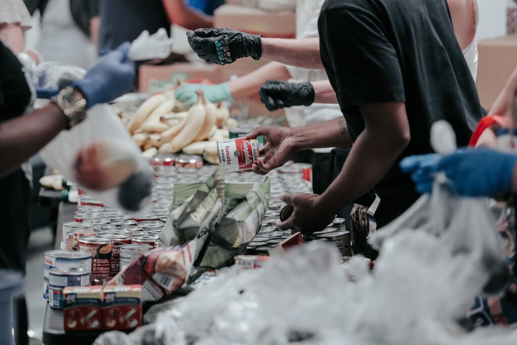 People at a food bank handing out products.