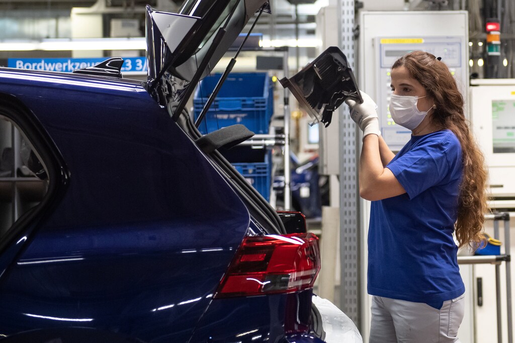 A worker wears a protective mask at the Volkswagen assembly line after VW re-starts Europe's largest car factory after coronavirus shutdown.