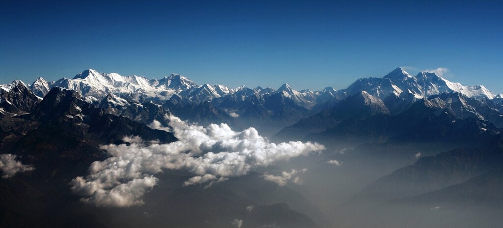 Mount Everest (2nd R), the world highest peak, and other peaks of the Himalayan range are seen from air during a mountain flight from Kathmandu April 24, 2010. REUTERS/Tim Chong (NEPAL - Tags: ENVIRONMENT TRAVEL) - RTR2RWME