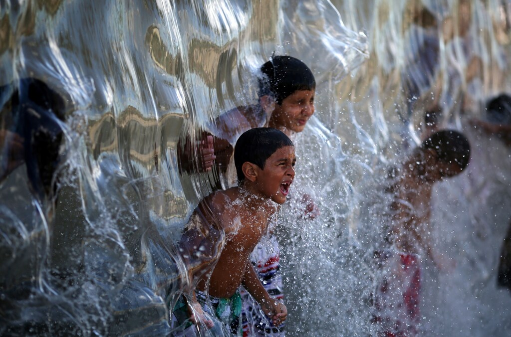 Children play with water in Madureira Park in Rio de Janeiro, Brazil.