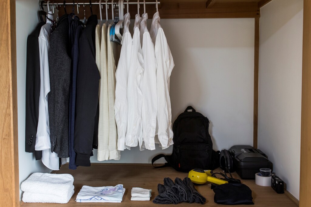 Clothes hang in the wardrobe of minimalist Katsuya Toyoda in Tokyo, Japan, March 5, 2016. REUTERS/Thomas Peter SEARCH "MINIMALISM" FOR THIS STORY. SEARCH "THE WIDER IMAGE" FOR ALL STORIES - S1AETKWNEPAD