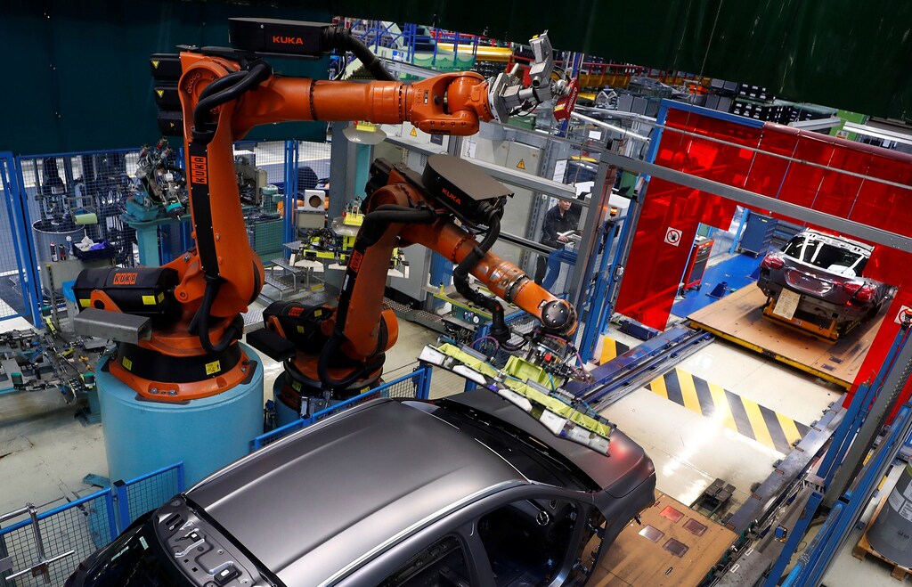 A robot engineered by Kuka adjusts a windscreen in a fully automated process on a model of the A-class production line of German car manufacturer Mercedes Benz at the Daimler factory in Rastatt, Germany, February 4, 2019. Picture taken on February 4, 2019. REUTERS/Kai Pfaffenbach - RC18ED249E90