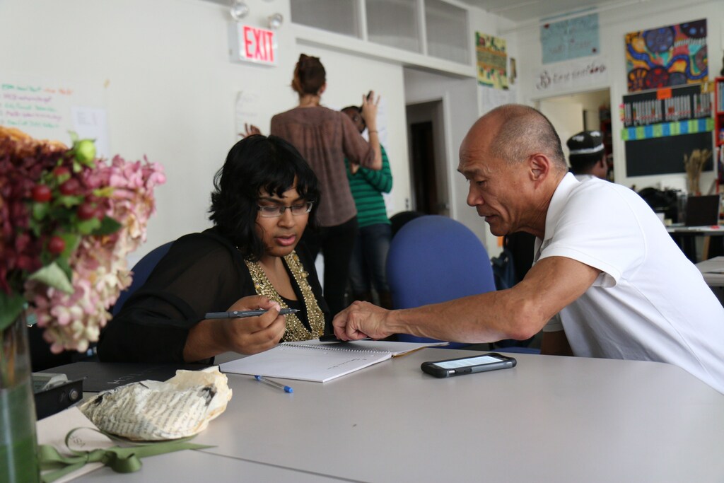a younger person working with an older person
