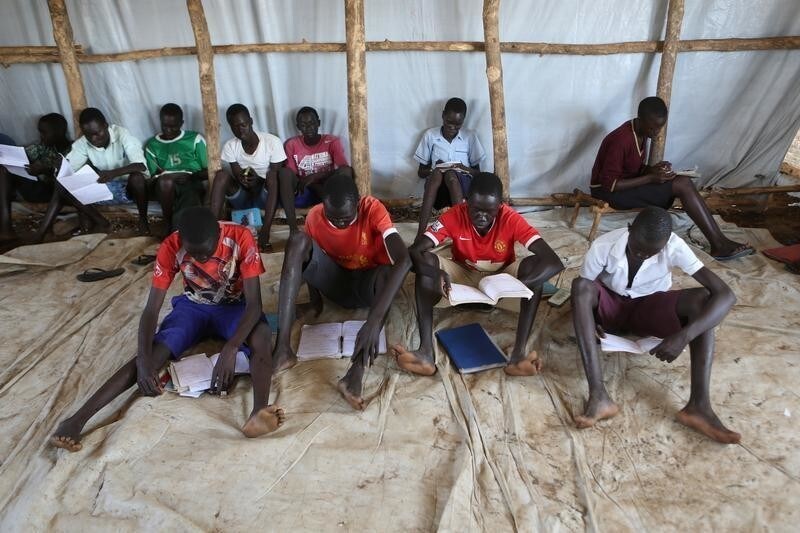 Youth who fled fighting in South Sudan attend classes in a tent at Bidi Bidi refugees resettlement camp near the border with South Sudan, in Yumbe district, northern Uganda December 7, 2016. REUTERS/James Akena