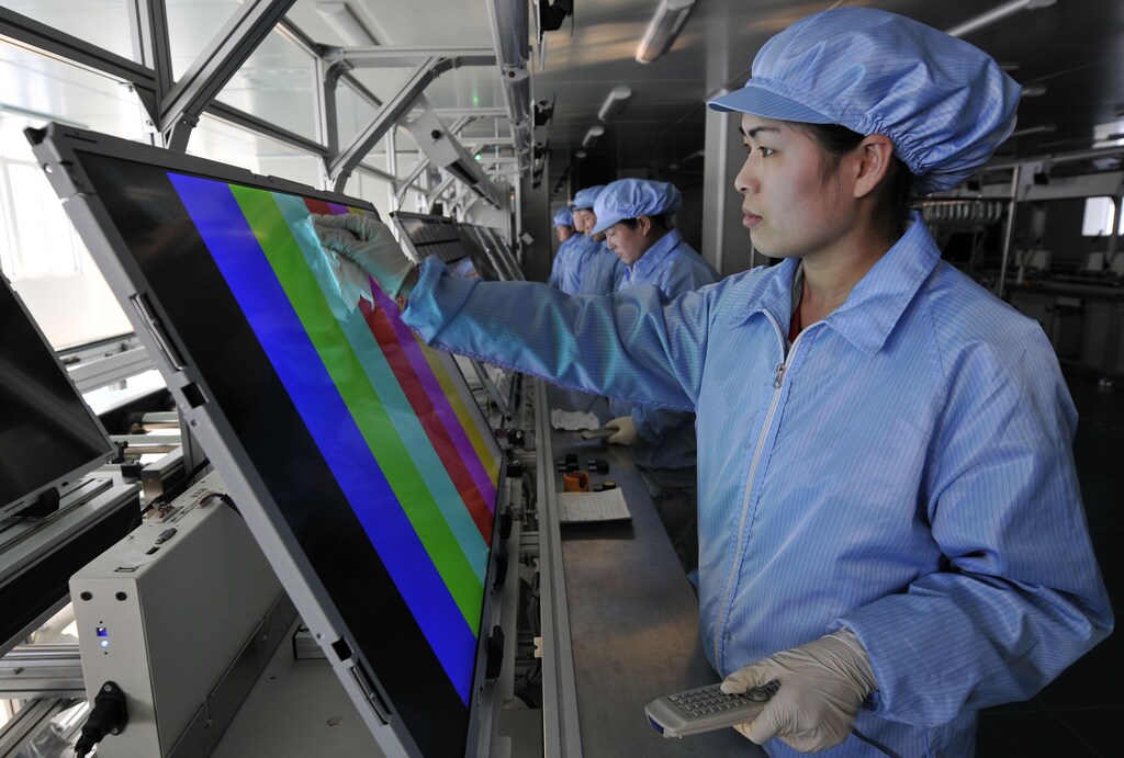 Employees clean and test newly made screens of LED televisions along a production line at a factory of Rizhao Hidear Electronics Co. Ltd in Rizhao, Shandong province March 1, 2011. Chinese manufacturing grew at its slowest pace in at least half a year in February, according to a pair of surveys, as the government's sustained campaign to tame inflation weighed on industrial activity. REUTERS/Stringer (CHINA - Tags: SCI TECH BUSINESS) CHINA OUT. NO COMMERCIAL OR EDITORIAL SALES IN CHINA - GM1E7311EMG01