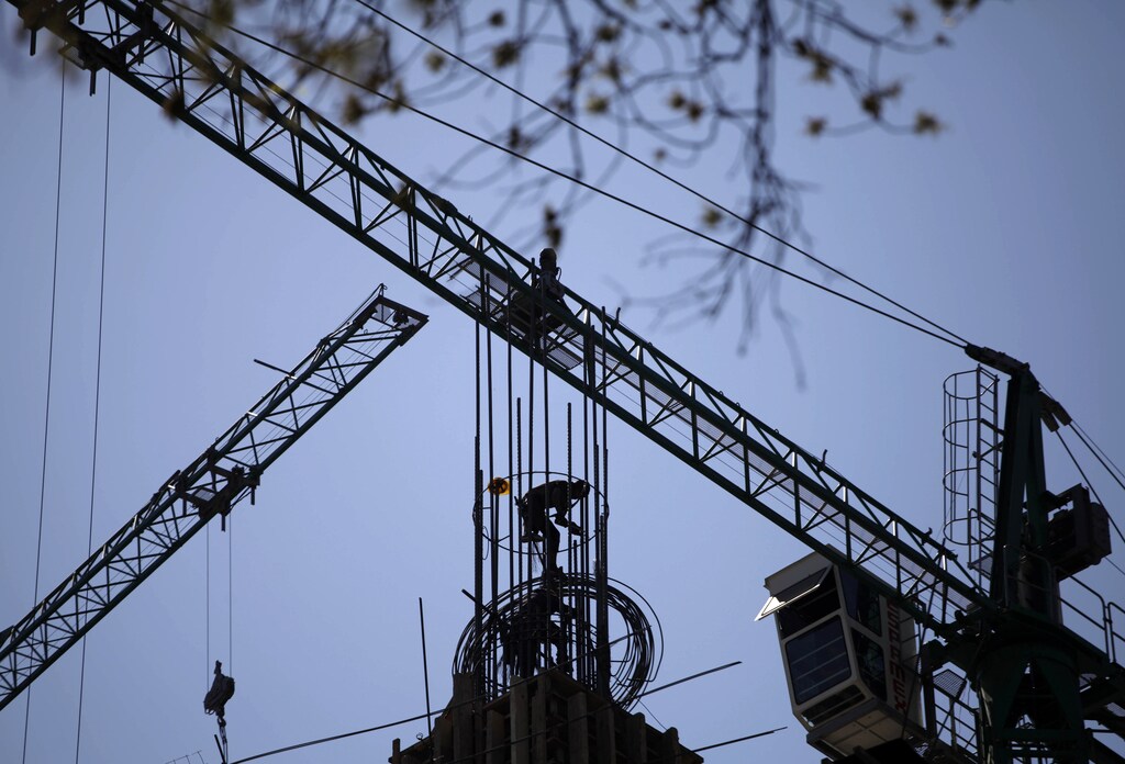 A worker stands on a structure at a construction site in Mexico City January 25, 2011.