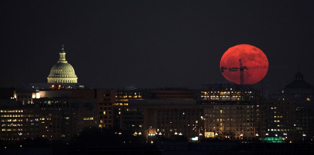 The Moon is seen as is rises in Washington, D.C., U.S. in this December 3, 2017 handout photo. The full Moon is the first of three consecutive supermoons. The two will occur on Jan. 1 and Jan. 31, 2018. A supermoon occurs when the moons orbit is closest (perigee) to Earth at the same time it is full. Bill Ingalls/NASA/Handout via REUTERS ATTENTION EDITORS - THIS IMAGE WAS PROVIDED BY A THIRD PARTY. MANDATORY CREDIT. - RC11307D30A0