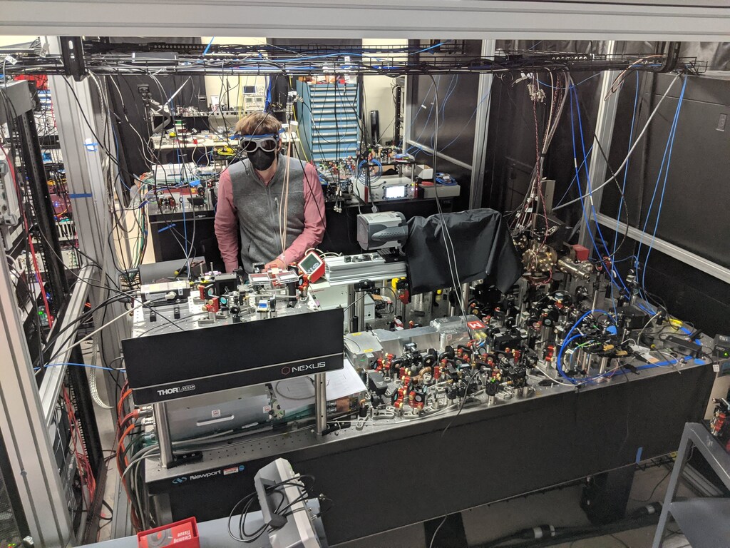 Quantum computer startup QuEra Computing's 256-qubit machine and Florian Huber, one of the team of scientist that built the machine.