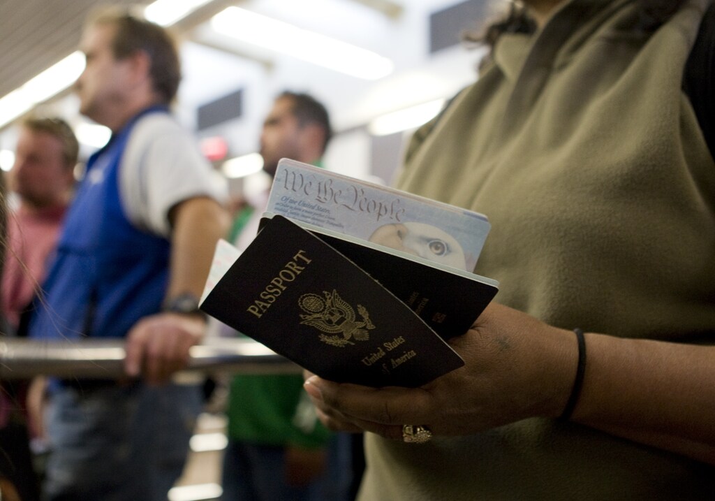 A pedestrian holds her and her child's passport while waiting to cross into the United States from Mexico at the San Ysidro border crossing in San Ysidro, California January 31, 2008.