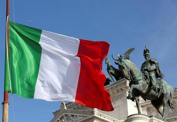 The Italian flag waves in front of The "Altare della Patria" also known as "Vittoriano" downtown Rome, Italy, March 23, 2016.