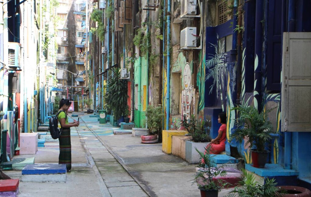 Visitors taking pictures at one of the back alleys that have been upgraded with the help of Doh Eain in downtown Yangon, Myanmar, on Nov 1, 2019.