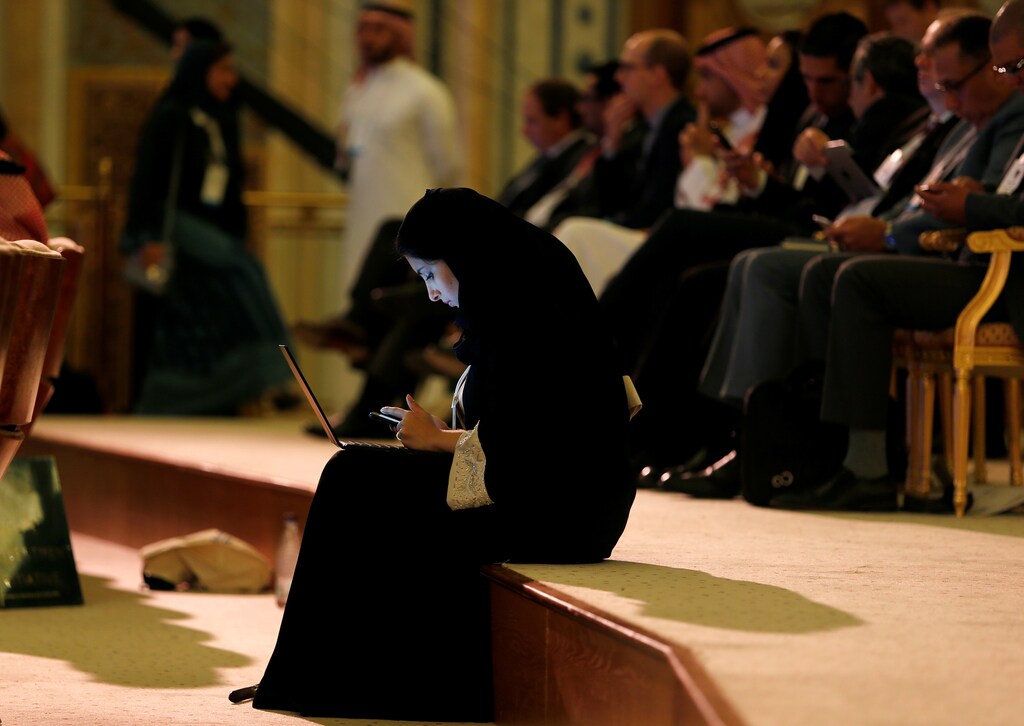 A woman uses her laptop during the Future Investment Initiative conference in Riyadh, Saudi Arabia October 24, 2017. REUTERS/Hamad I Mohammed - RC18FAB18AC0