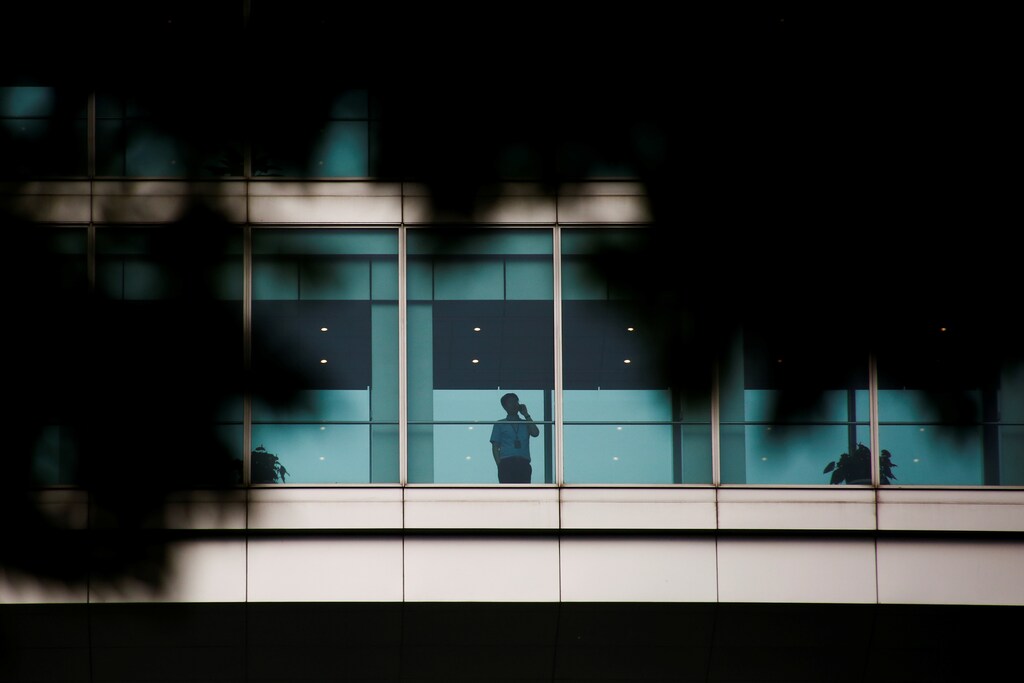 A man talks on the phone as he looks out from a window of the headquarters of the ICBC bank in Beijing, China June 12, 2017. Picture taken June 12, 2017. To match Special Report ICBC-SPAIN/ REUTERS/Thomas Peter - RC1C0904F800