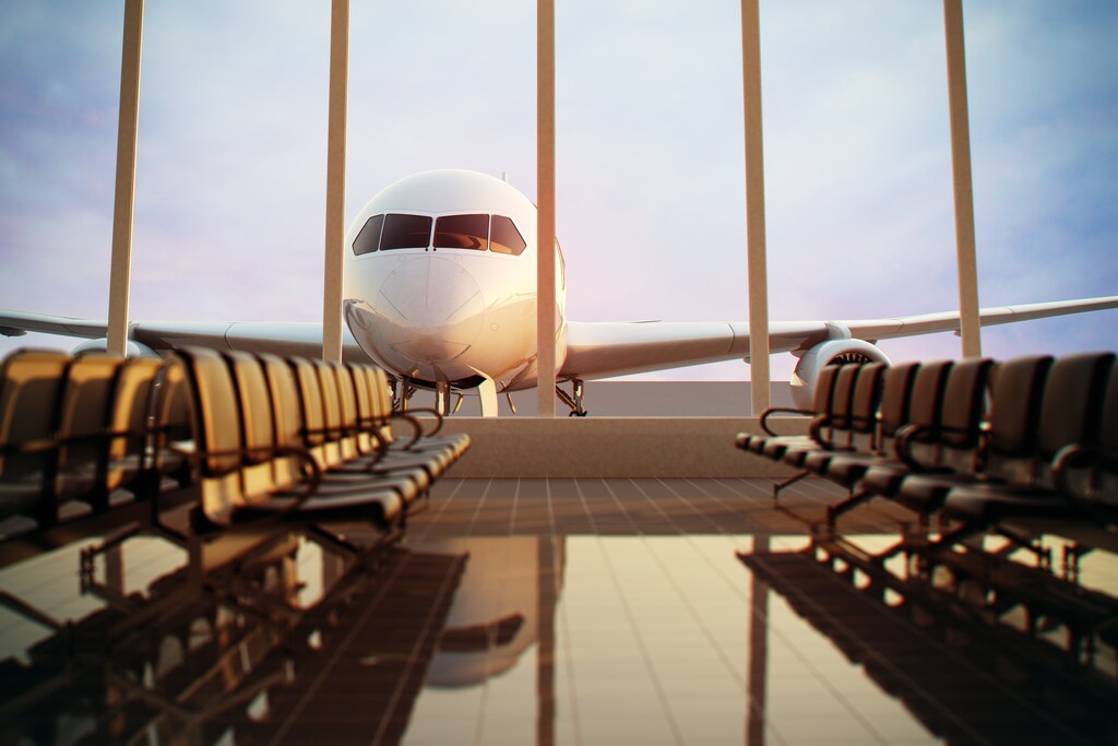 An aeroplane parked outside an airport, illustrating the future of airports