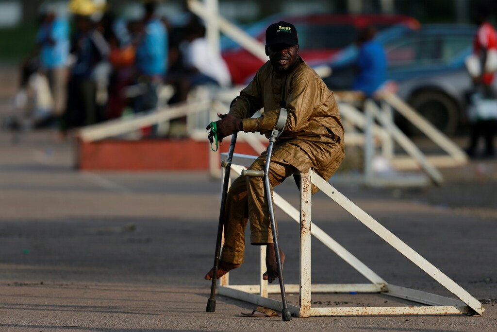 A victim of polio disease sits on a goal pole during a game of para-soccer in Abuja, Nigeria August 22, 2020. Picture taken August 22, 2020. REUTERS/Afolabi Sotunde - RC2XKI9JC77H