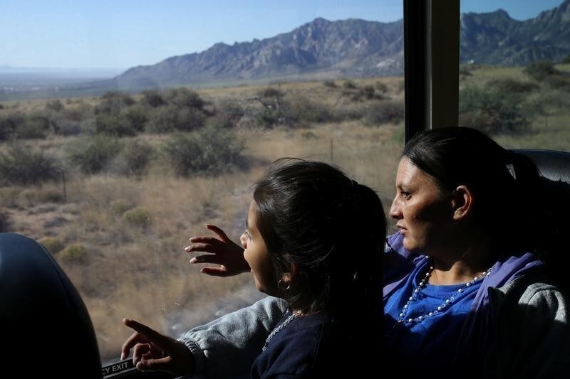 Orfa, a migrant from Honduras, and her daughter Rachel look out of the window of a Greyhound bus during a leg of the journey from El Paso, Texas, U.S., to Portales, New Mexico, U.S., May 16, 2018. REUTERS/Loren Elliott SEARCH "ELLIOTT ORFA" FOR THIS STORY. SEARCH "WIDER IMAGE" FOR ALL STORIES. TPX IMAGES OF THE DAY - RC113B8DA530