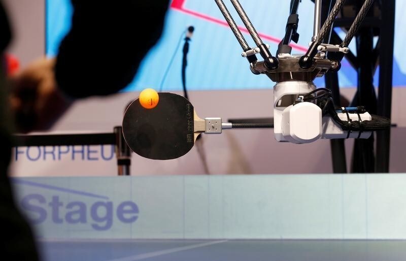 "Forpheus," an AI-equipped robotic ping pong tutor, returns a ball during a lesson in the Omron booth at the 2019 CES in Las Vegas, Nevada, U.S. January 9, 2019. REUTERS/Steve Marcus - RC17130725B0