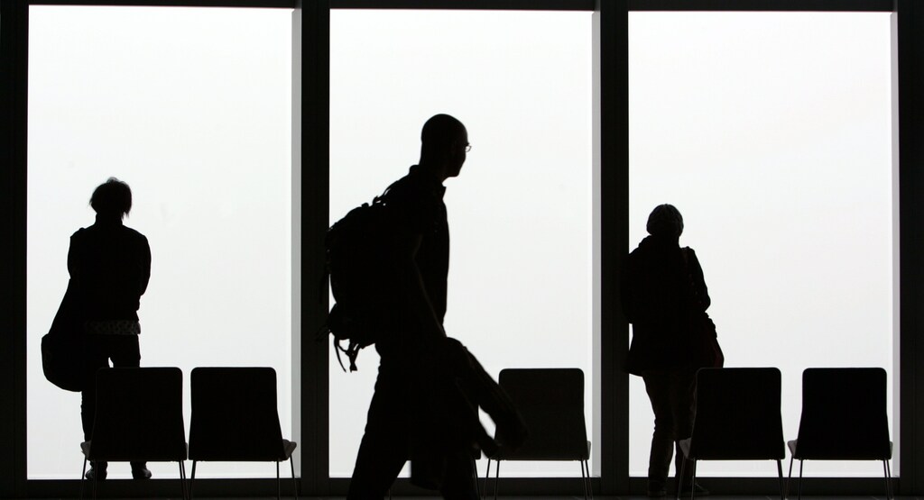 Visitors is silhouetted against a cloudy sky on the observation deck of a skyscraper in Tokyo February 23, 2007. REUTERS/Kim Kyung-Hoon (JAPAN)Also see GF2DWTFXPQAA - GM1DUREDCSAA